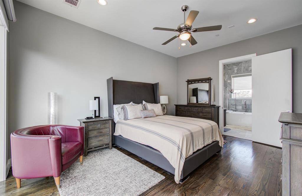 Primary suite, located on the 3rd floor, boasts high ceilings, floor to ceiling windows with custom, black-out automatic  window shades