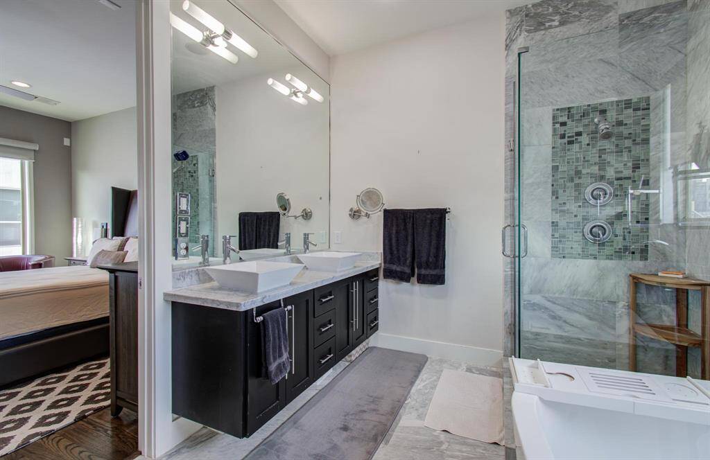 Another view of the primary bath with double sinks, walk in shower and separate soaking tub!