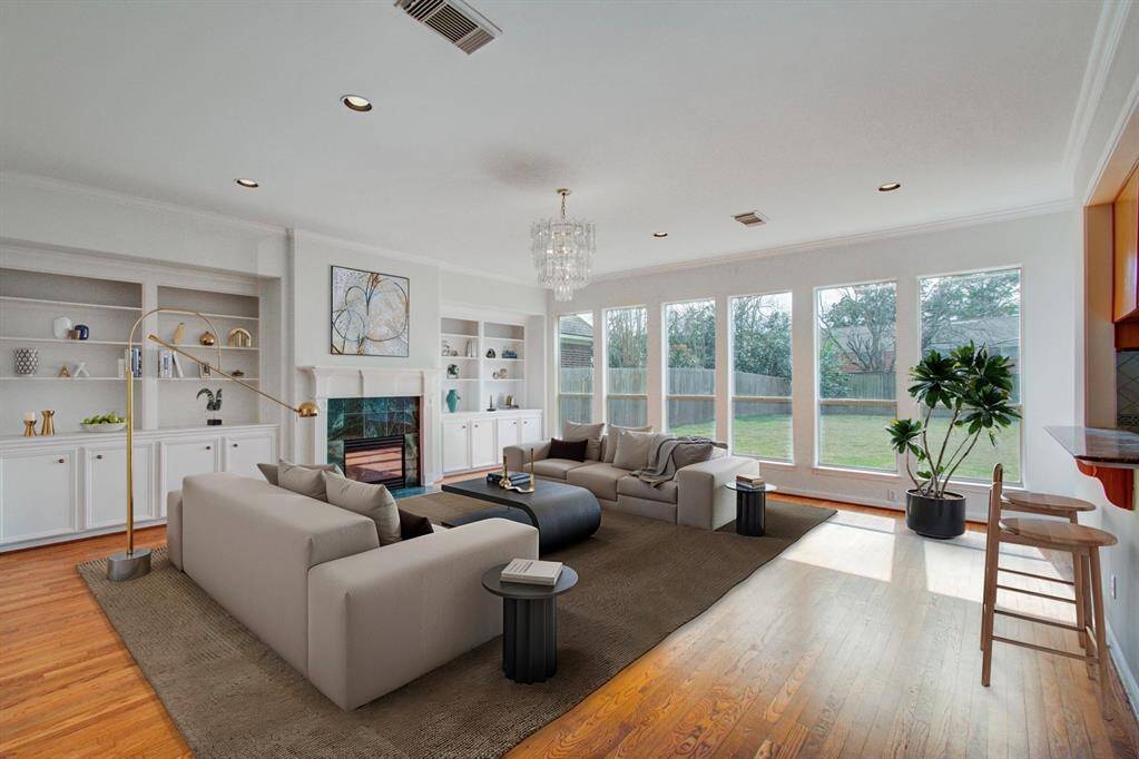 Spacious living room with lots of natural light and a fireplace