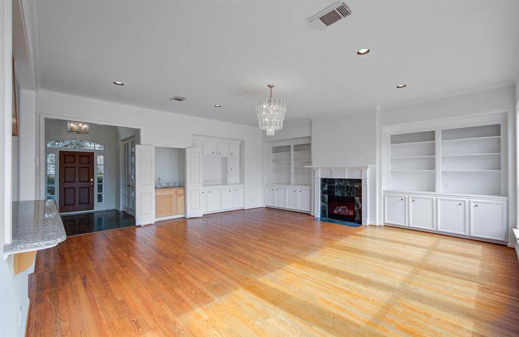 Spacious living room with lots of natural light and a fireplace