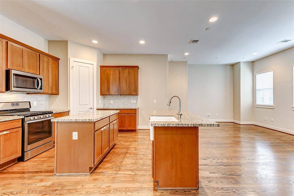 Open kitchen with island and breakfast bar. Great for entertaining.