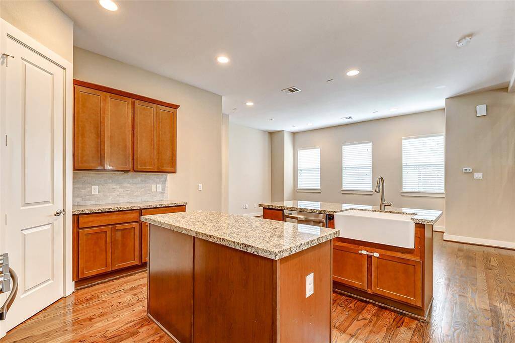 Large beautiful porcelain sink looking into living room and the wall of windows