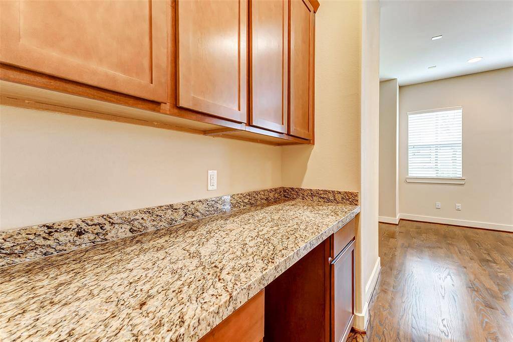 Large counter and cabinets at entrance to half bath on main floor