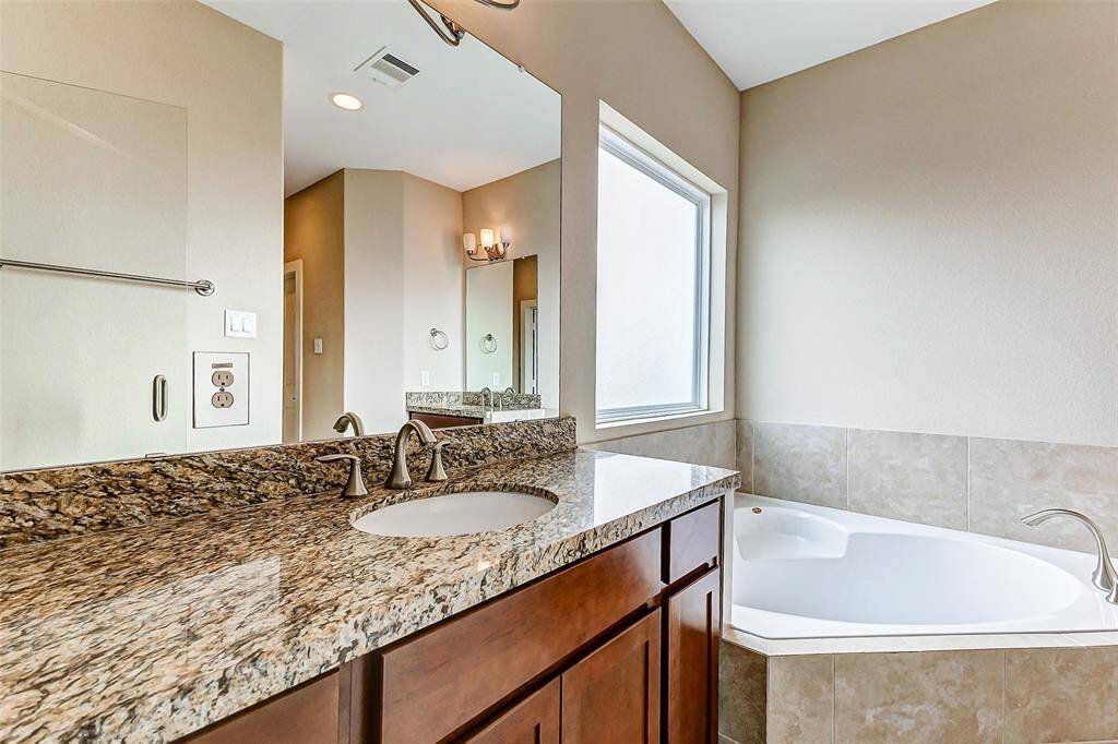 Two separate sinks, mirrors and vanities  primary bathroom; ;tub and shower separate