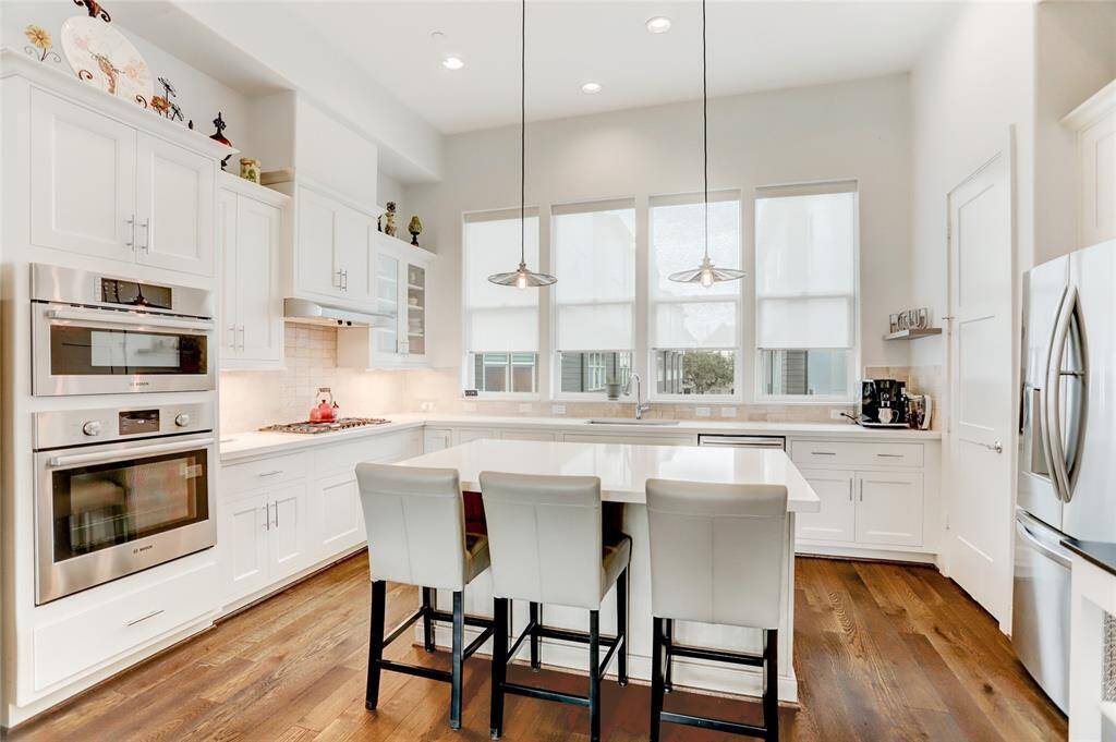 Another look at the kitchen, complete with stainless steel appliances and a nice view down the main driveway of the Capitol Oaks community.