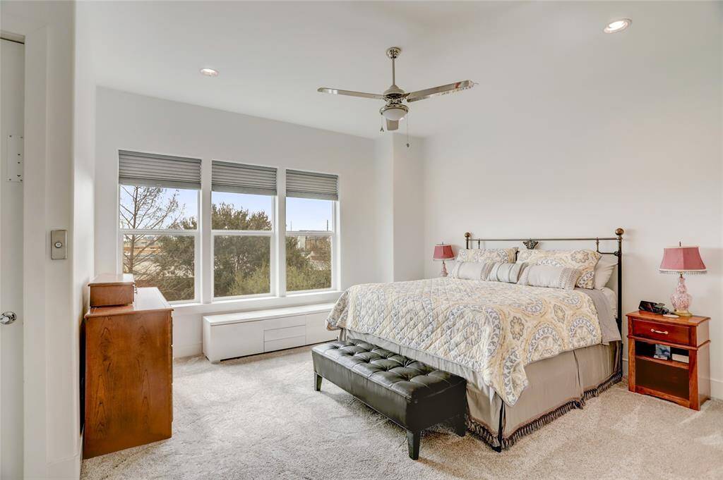 The primary bedroom, with the door on the left leading to the elevator. The bathroom is just out of frame to the right.