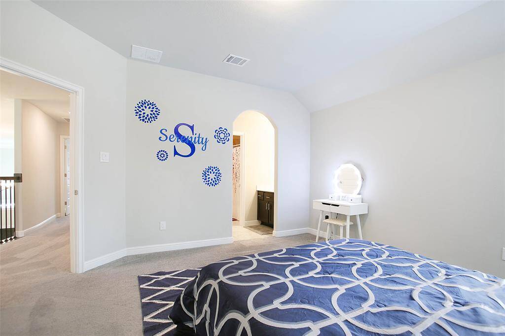 The thoughtful design allows for easy access to the bathroom while maintaining privacy, with separate vanity areas on each side.