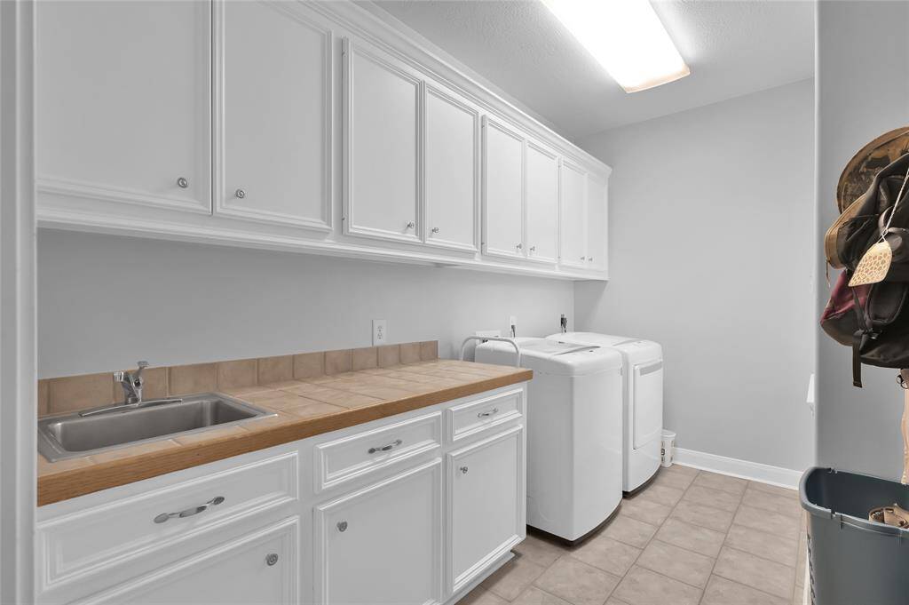 Large laundry room just off of the garage. This room has tons of cabinet and storage space.