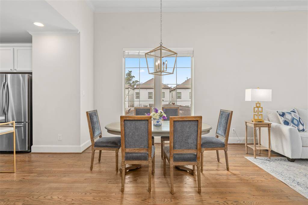 The dining area [10' x 9']  has an attractive farmhouse-inspired light fixture and overlooks the new and recent construction in the neighborhood.