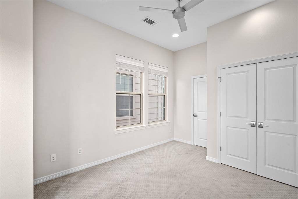 The second bedroom [14' x 10' approximately] suite is situated on the third-floor corner upstairs. There are double doors to the closet. The entrance to the ensuite bathroom is on the left.