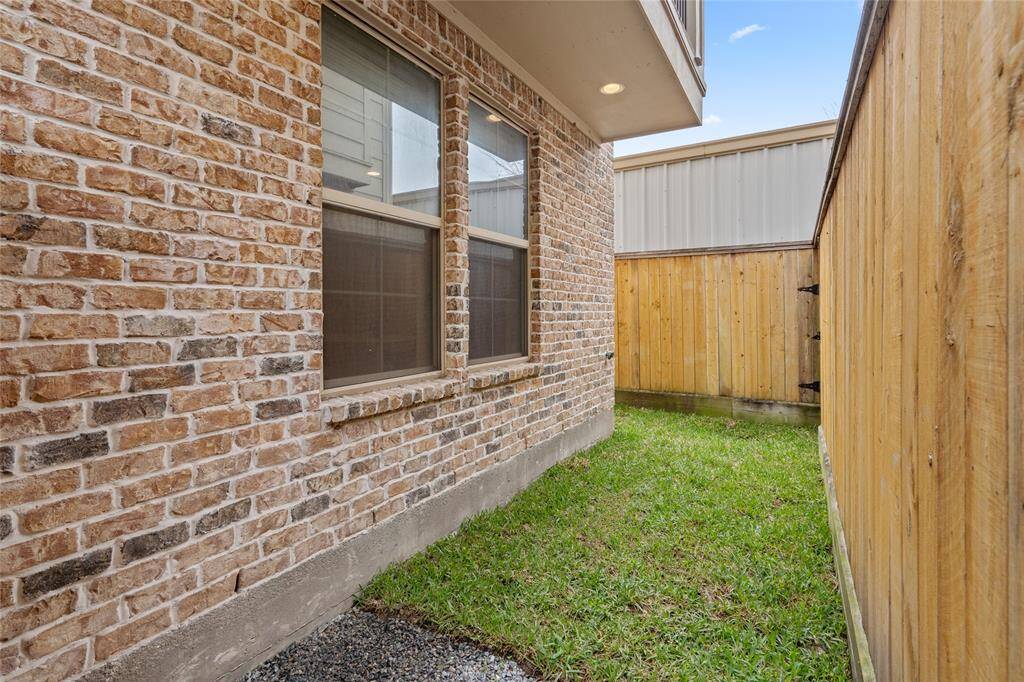 Upon entering the gardener gate on the immediate right of the front door, step on the stones that lead you to the grassy L-shaped yard. Perfect spot to add an herb garden or plants to attact butterflies.