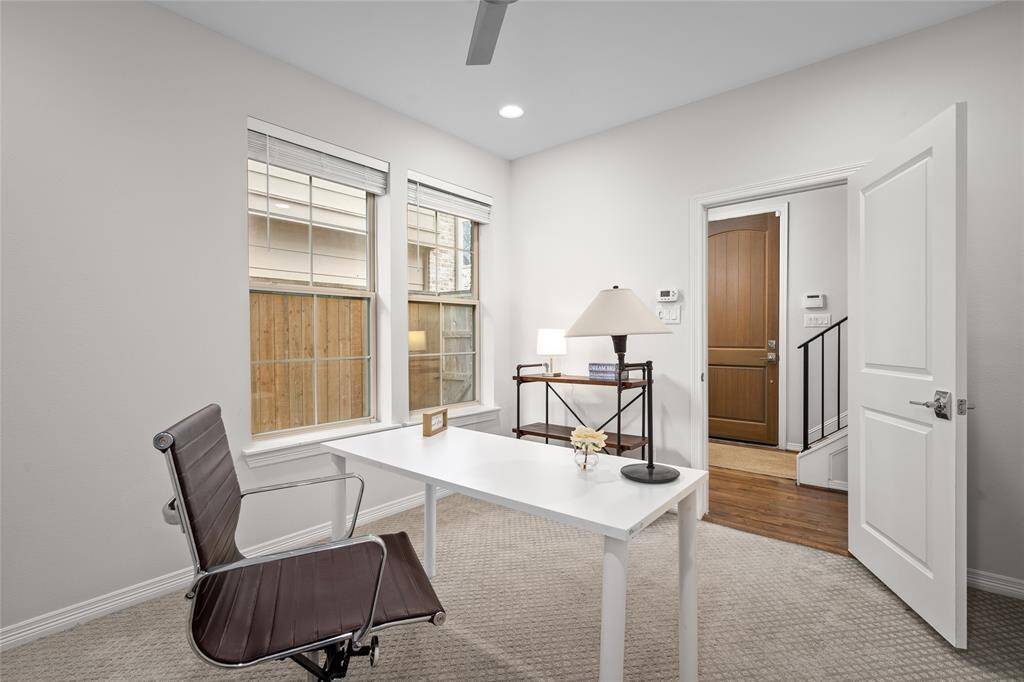 The home office is also a downstairs guest bedroom suite [12' x 10']. Wonderful natural light filter through the pair of mirror-image windows. The foyer is visible in the background.