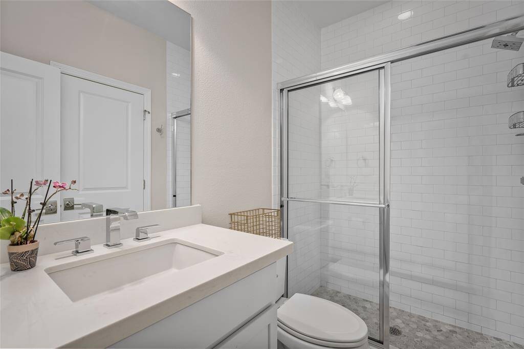 The pretty first-floor ensuite bathroom is ideal for guests staying with you for a weekend visit. The closet door is in the mirror's reflection.