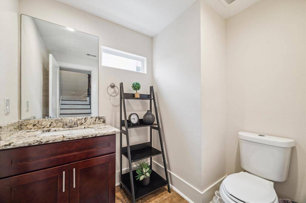 Powder Room located off the stairwell allows privacy.