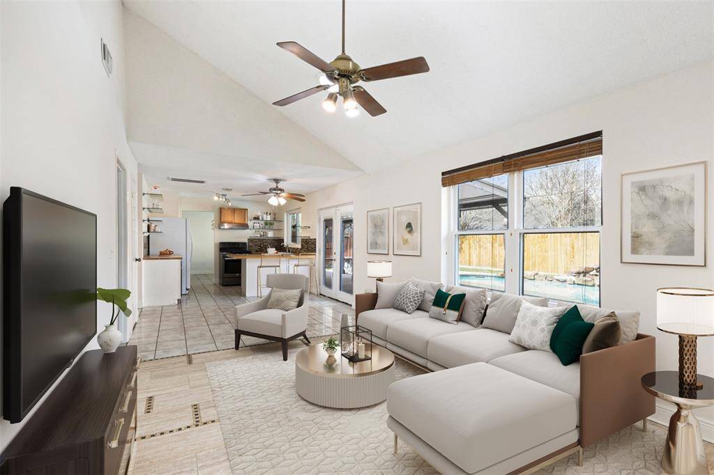 Amazing living room with high ceilings and great views of the backyard. (Virtually Staged)