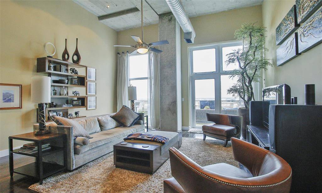 Living area has ample windows and opens to the private terrace. Art Deco shelving adds a sophisticated flare to display your favorite decorative pieces and will stay to new owner.