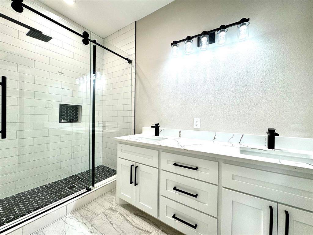 Custom cabinetry and walk in shower.