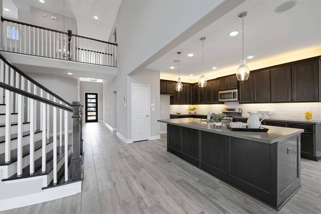 The entry door is contemporary featuring six glass openings.  It sets the tone for the rest of the doors in the house with raised panels and chrome hardware.