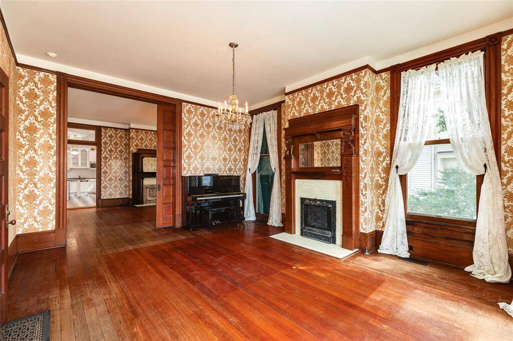 The modern day living room is on the Southeast side of the home and adjacent to the dining room. This room features the first of 8 fireplaces.