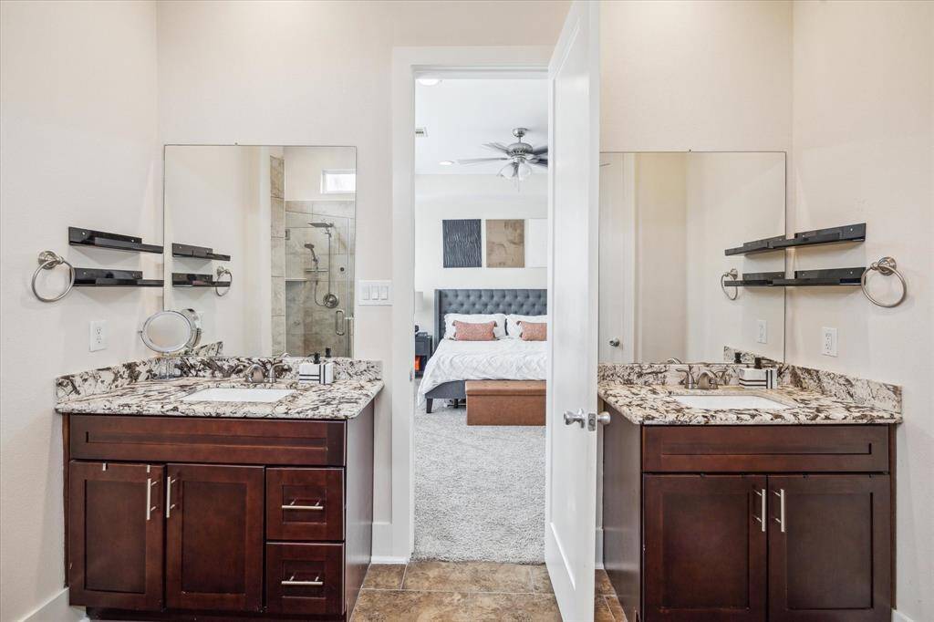 Primary Bathroom features two separate vanity areas with tons of storage, a walk in shower and a separate tub.