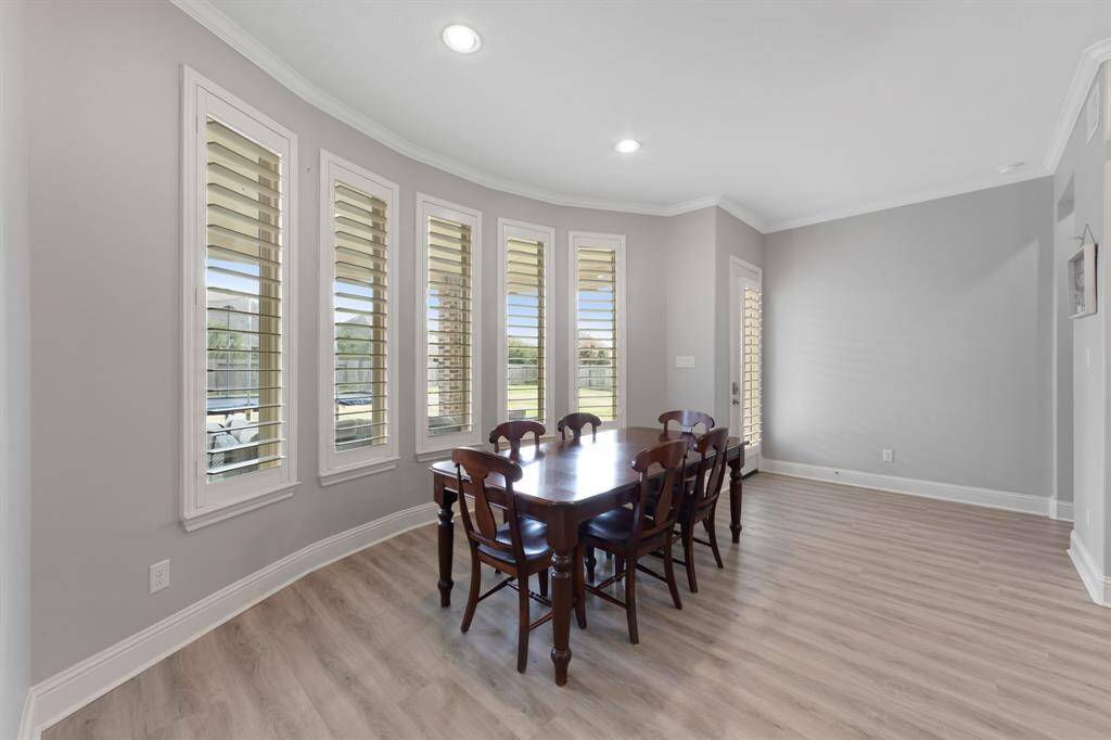 The cozy breakfast area, featuring a charming bay window, offers a perfect spot to enjoy your morning coffee while taking in views of the backyard and surrounding landscape.