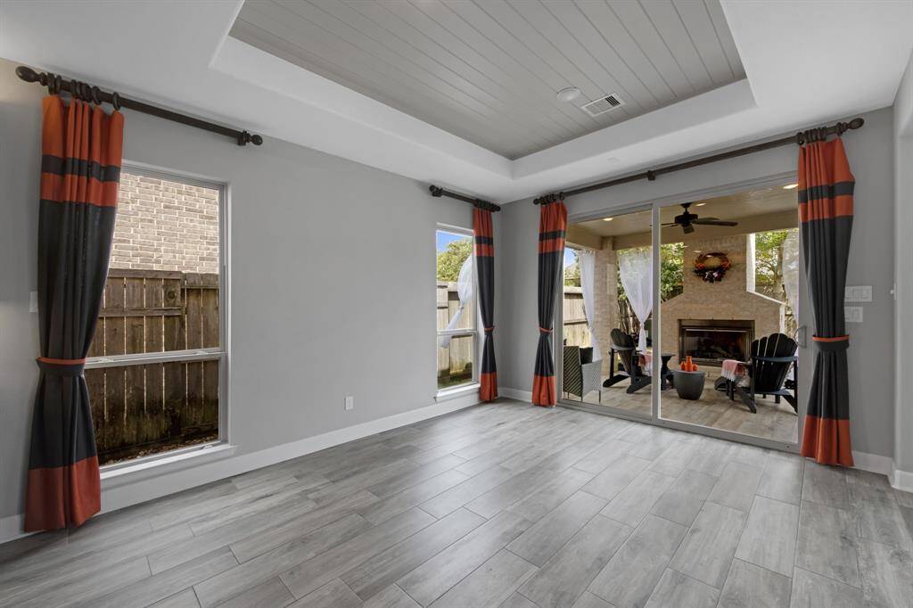 The wide opening sliding door ($3,750.00) provides easy access to the beautiful back porch.  The tray ceiling has painted "Tongue and Groove" panels ($1,500.00) and specialty LED lighting.