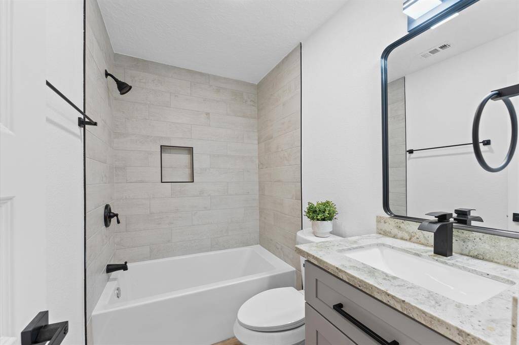 Restrooms have been beautifully updated with modern finishes, and contemporary style that enhance the home's appeal.