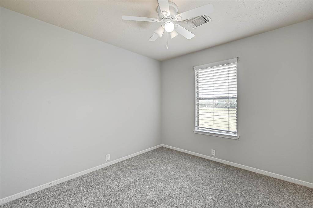 The stairs lead to a spacious primary bedroom with attached bath, two secondary bedrooms, and another full bath.
