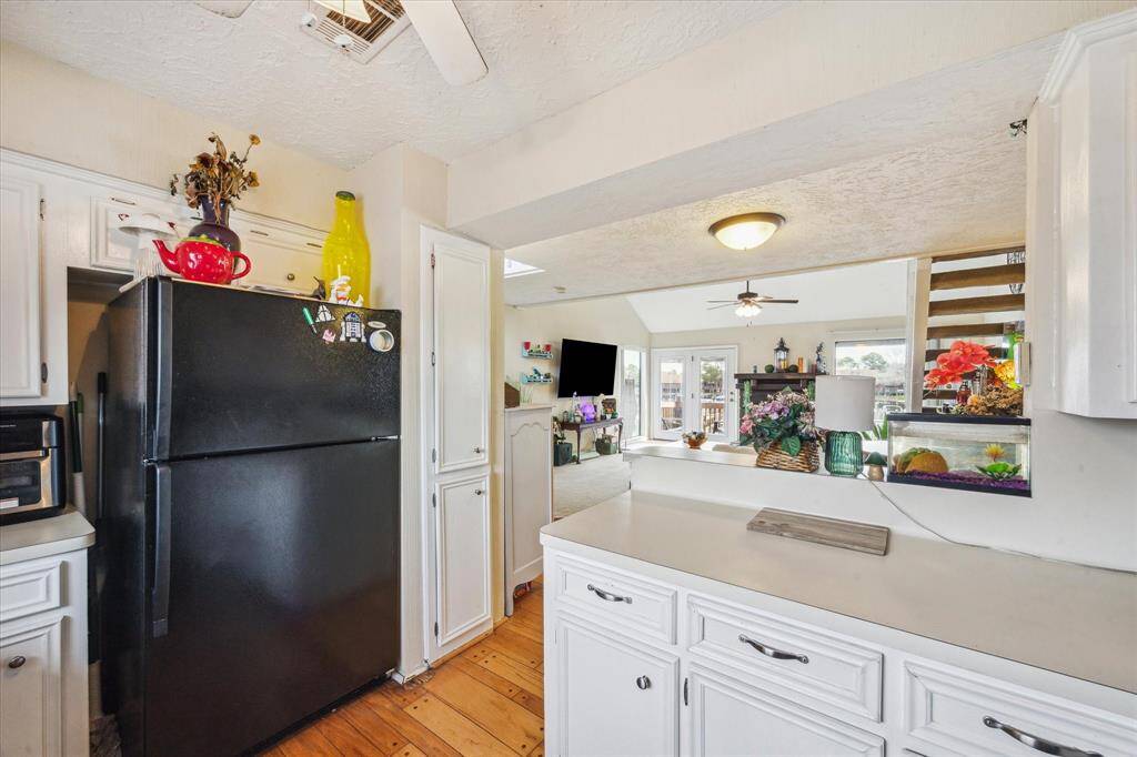 THE KITCHEN BREAKFAST BAR OPENS TO THE DEN.