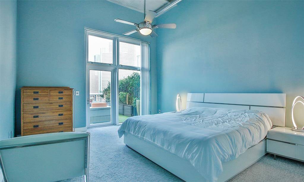 Spacious (16X13) primary suite features designer paint, plush carpet, ceiling fan, and door leads to your private terrace.