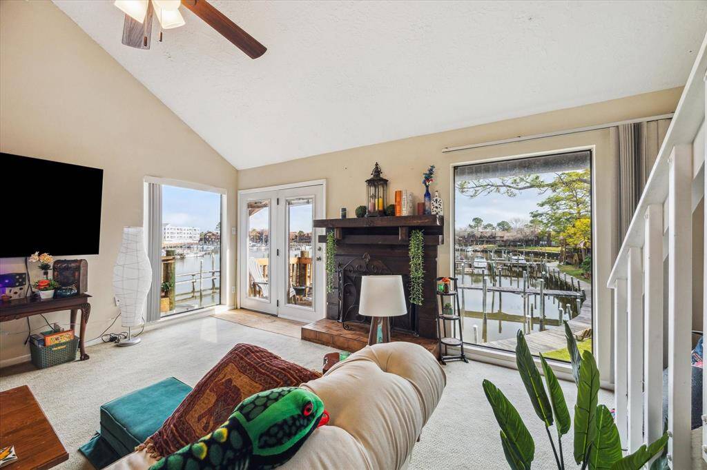 LARGE WINDOWS AND SLIDING GLASS DOORS LEADING TO THE WATERVIEW BALCONY.