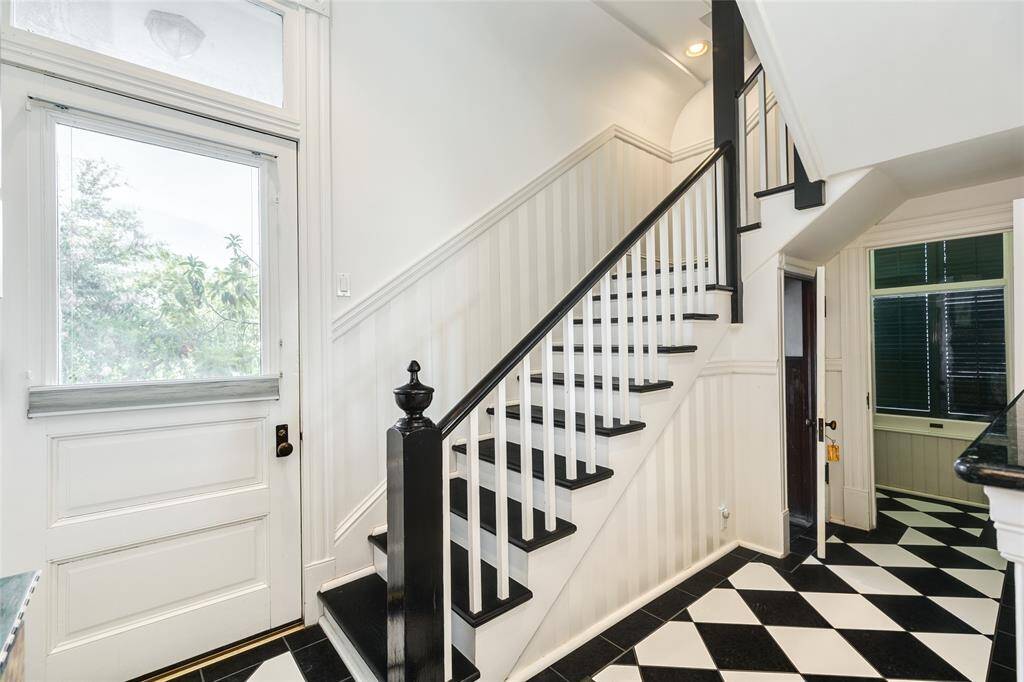 This set of back stairs is just inside of the side entrance off 15th Street. The stairs are original and go up to the living quarters. Under the stairs is a door to the basement and just beyond is a walk-in pantry and dry storage.