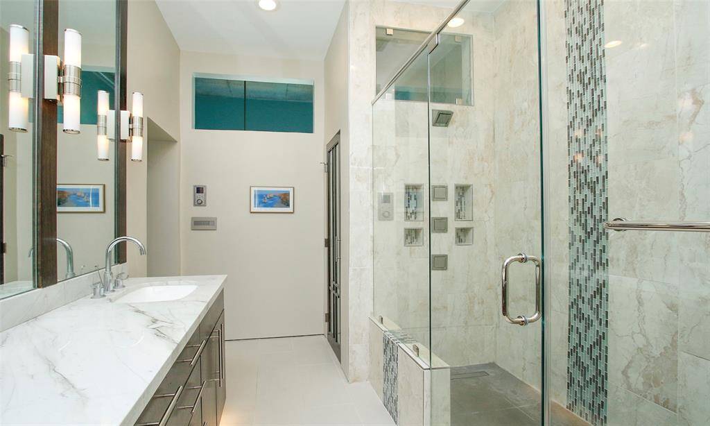 Spa-like shower has it ALL!! Kohler rain shower and panel with multiple body massage jets and sprayers. Programable unit will have your perfect shower temperature set when you are ready to step in.