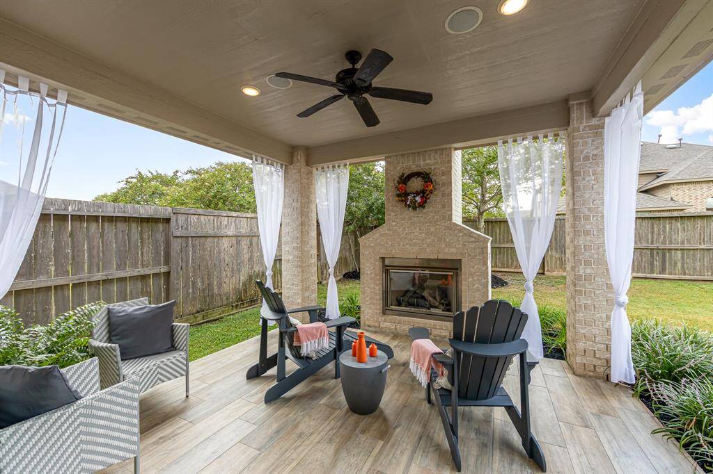 ...A cozy spot to drink coffee in the morning or to wind down in the evening. This is an upgraded covered patio with a gas/wood fireplace ($4,850.00), "wood" ceramic tile, 2 recessed lights (cans) ($360.00), 2 built-in speakers and an outdoor ceiling fan ($260.00).