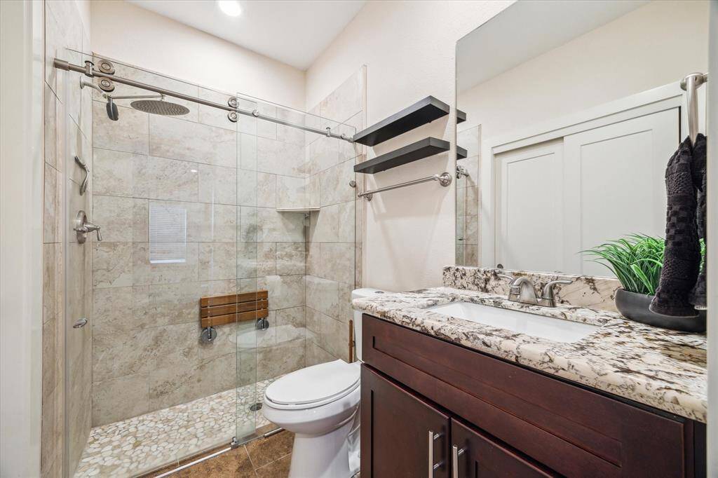 En suite bathroom features a standing shower.