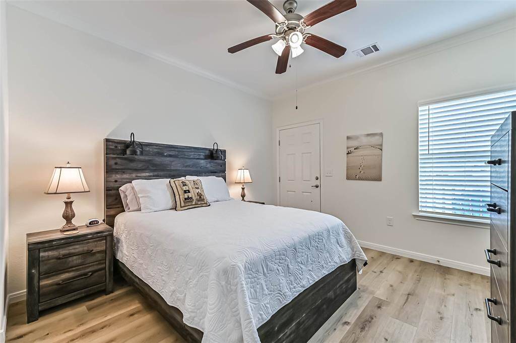 Luxurious primary bedroom with direct access to a private rear deck.