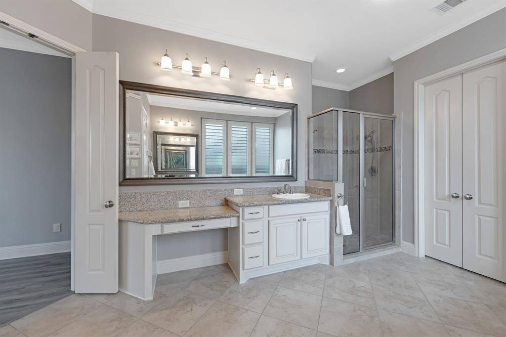 The walk-in shower is a luxurious feature, equipped with two shower heads for an indulgent and customizable shower experience.