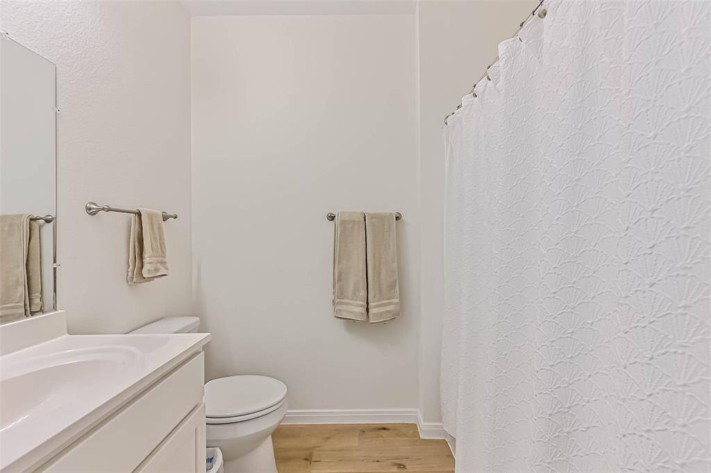 Sleek primary bath with modern fixtures, ample natural light, and elegant finishes. Perfect for relaxation and style.