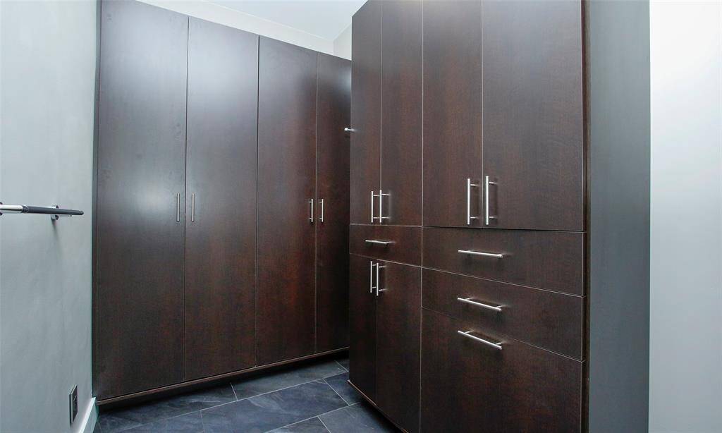 Closet factory designed closet with slate tile flooring.