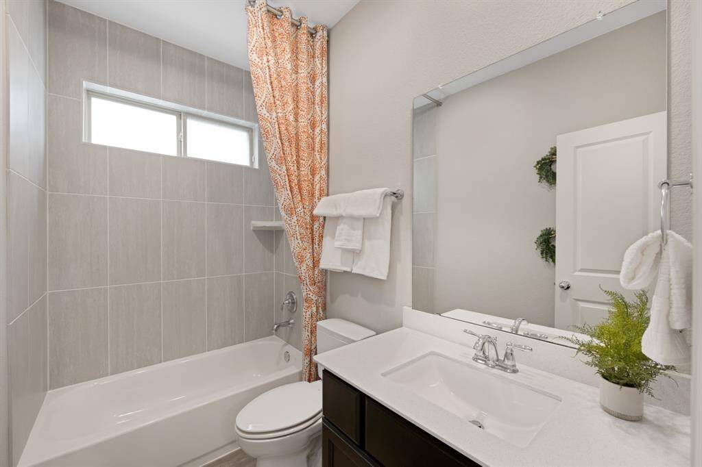 This is the full bathroom on the 1st floor.  It has "tub to ceiling" tile (except the window) ($260.00) and a custom "floor to ceiling" designer curtain to accent the future shower curtain (purchased by buyer).