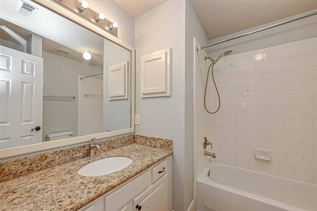 Secondary bath with shower/tub combo.