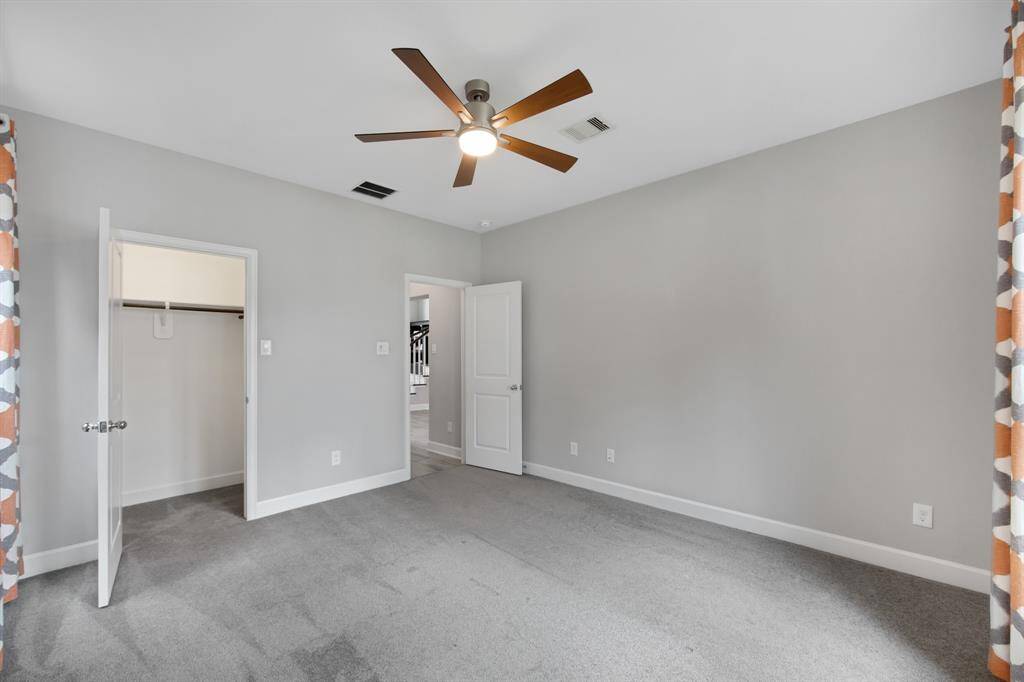 The door on the left leads to the walk in closet and the door on the right leads to the hall and secondary full bathroom.