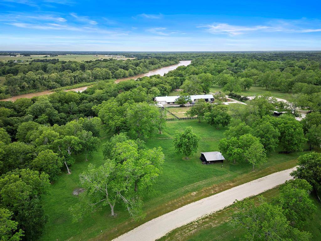 This spacious acreage lot with mature trees, backing up to the scenic Brazos River, provides the best slate to build your dream home.