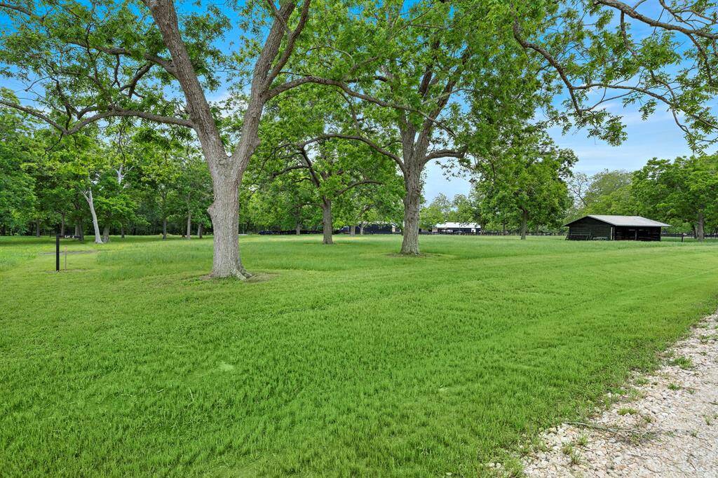 Spacious acreage lot with mature trees, backing up to the scenic Brazos River.
