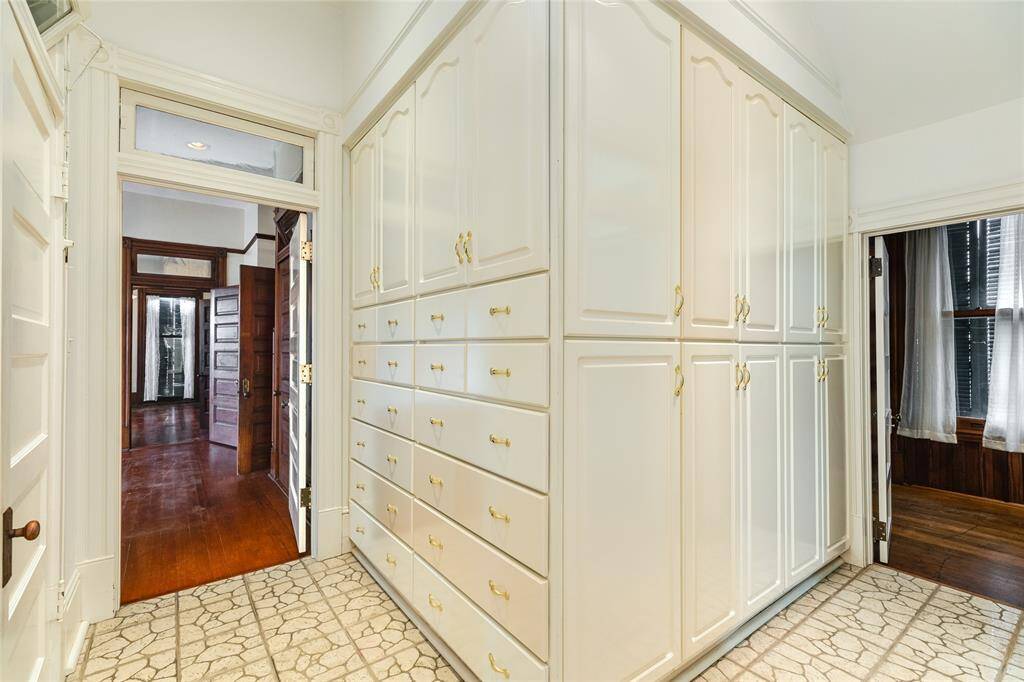 This view of the Primary en-suite shows the additional 13 linear feet of cabinetry storage. Not to be outdone by the walk-in pantry storage behind the door on the left in this photo. The door on the right goes to the laundry room and back steps to the kitchen.