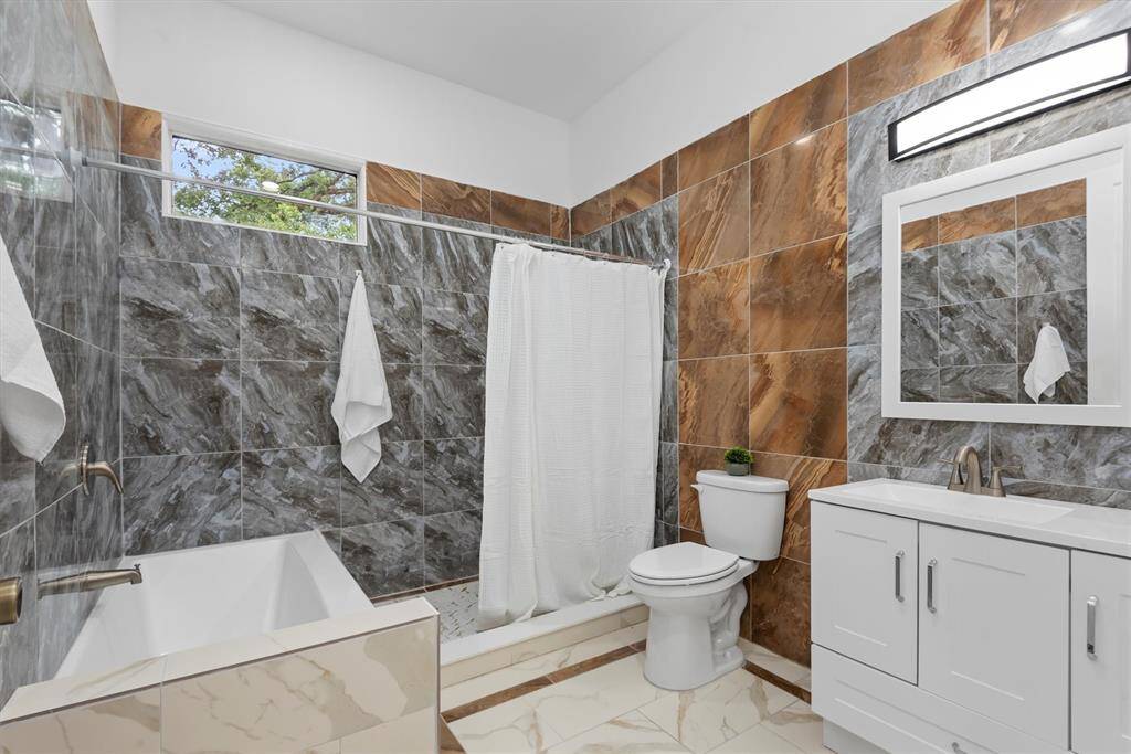 Full bath 1 attached to the bedroom with a large walk in shower and tub