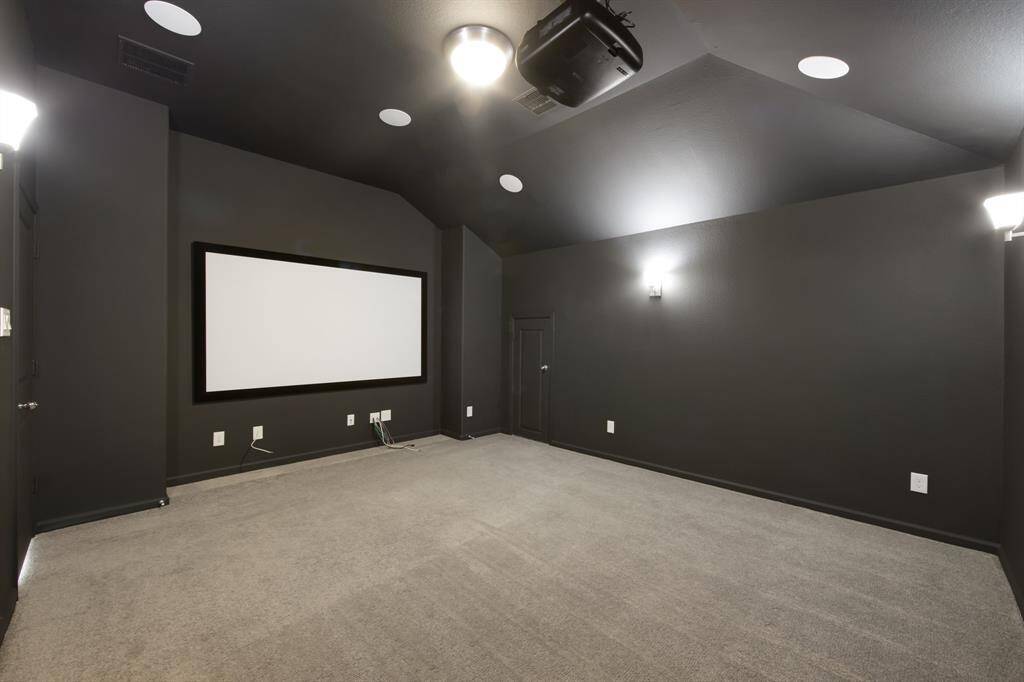 The media room ($20,000.00 structural addition) is a true media room, without windows.  It has custom paint to enhance the theater experience.  There are 4 wall sconces, a projector and screen, and speakers built in the ceiling.