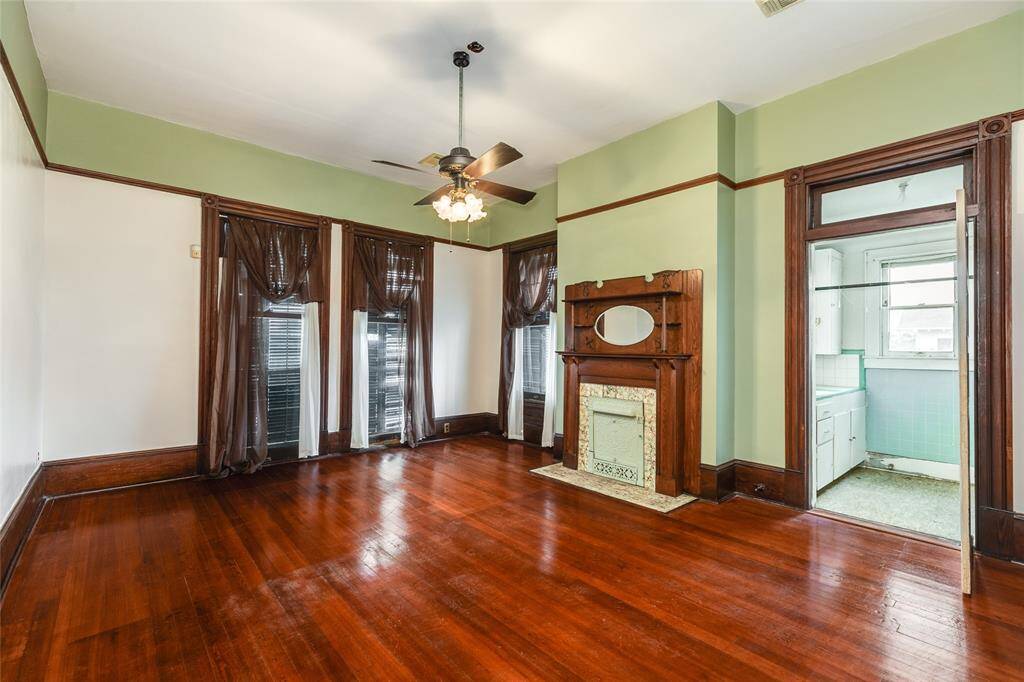 This bedroom is on the Southwest corner of the West wing upstairs and features another beautiful fireplace mantel, and a vintage morning kitchen (remaining from the days of housing med students).