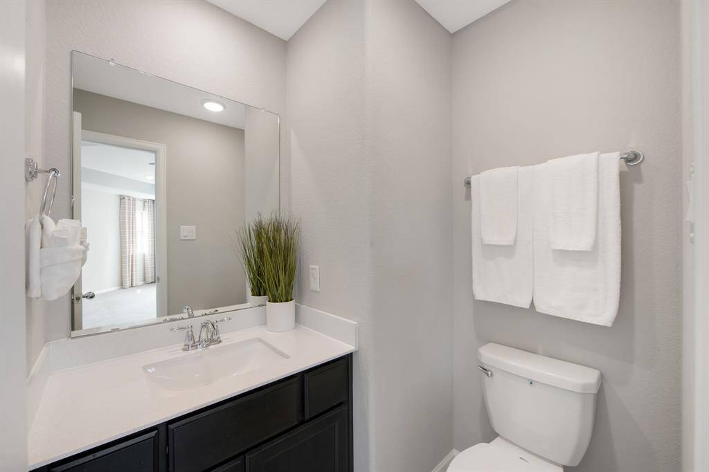 The upstairs 1/2 bath is in a convenient location off of the "game room", next to the media room.