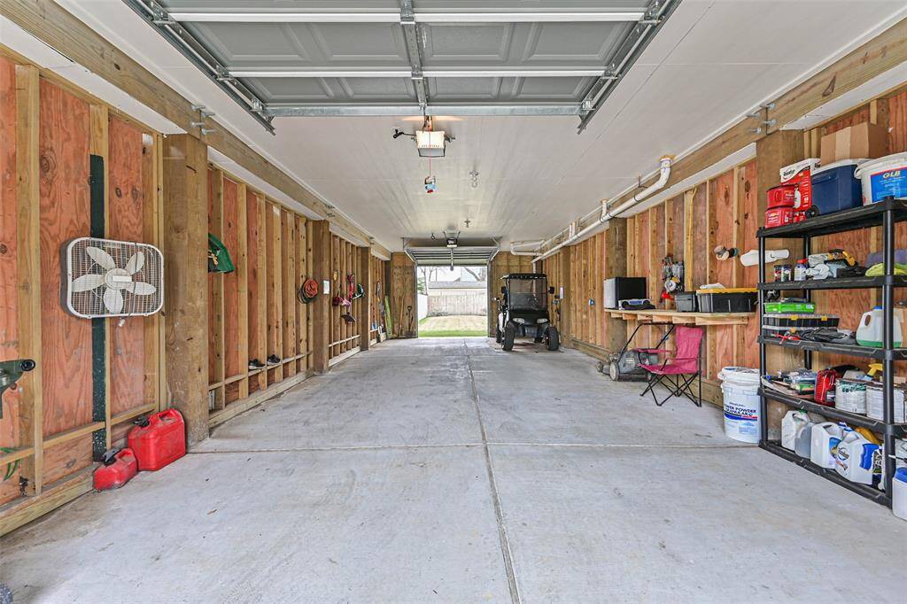 view of enclosed garage with both garage doors raised